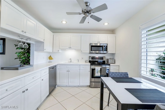 kitchen featuring white cabinets, decorative backsplash, stainless steel appliances, and kitchen peninsula