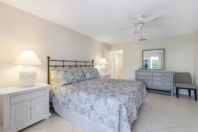 tiled bedroom featuring ceiling fan