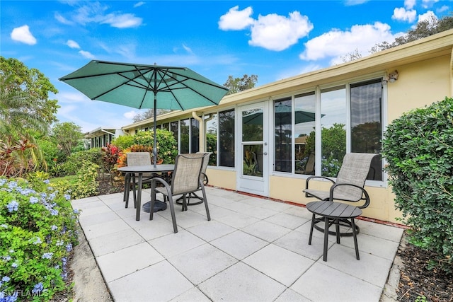 view of patio featuring a sunroom