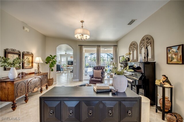 office space featuring ceiling fan with notable chandelier and light tile patterned flooring