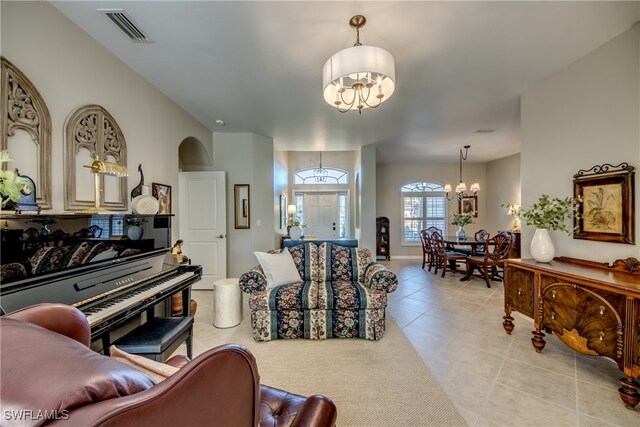 living room featuring light tile patterned floors and a chandelier