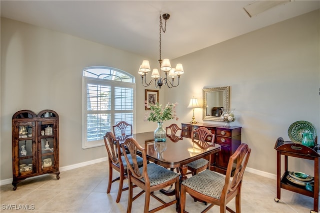 tiled dining space featuring an inviting chandelier