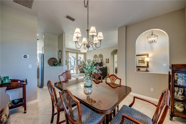 dining room with a notable chandelier and light tile patterned floors