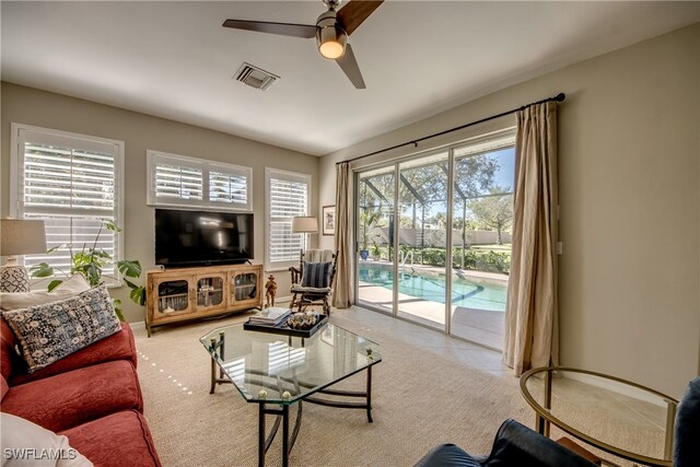 living room featuring ceiling fan and light tile patterned floors