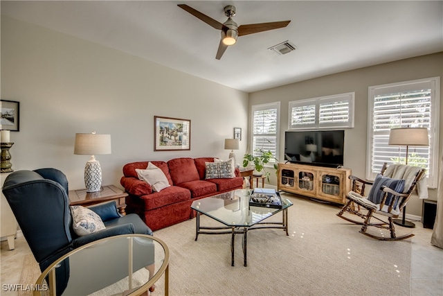 tiled living room with ceiling fan