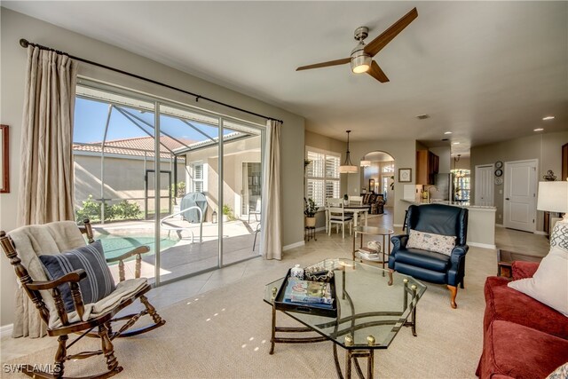 living room featuring light tile patterned floors and ceiling fan