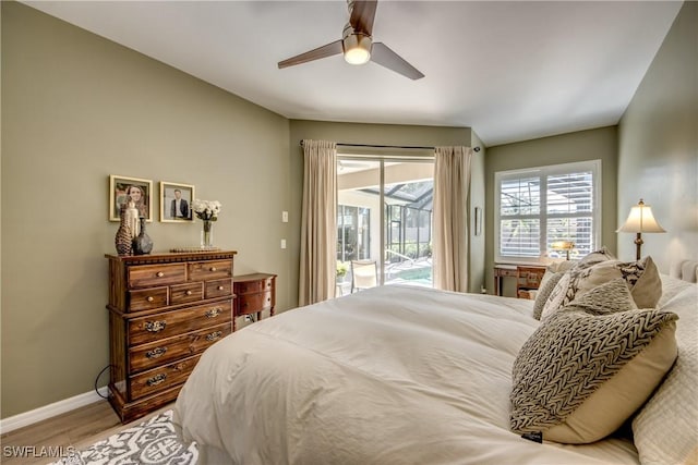 bedroom featuring ceiling fan, wood finished floors, baseboards, and access to outside