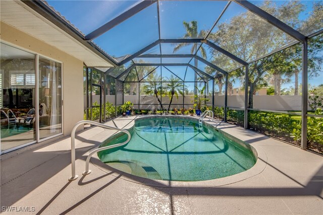 view of pool with a patio and a lanai