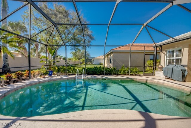 view of pool featuring area for grilling and a lanai