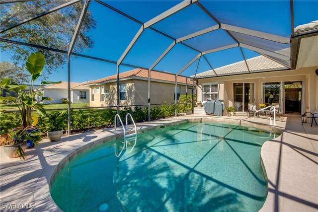 view of pool with a lanai and a patio