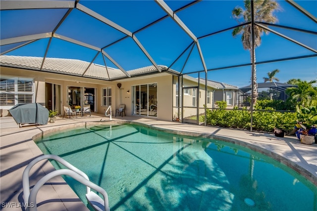 view of pool with a lanai and a patio