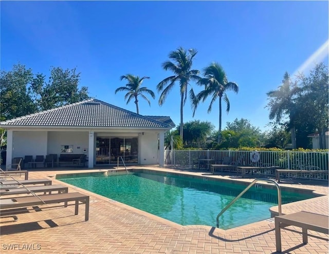 pool with fence and a patio