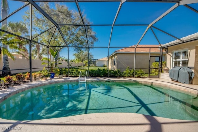 view of swimming pool with a lanai, a grill, and a fenced in pool