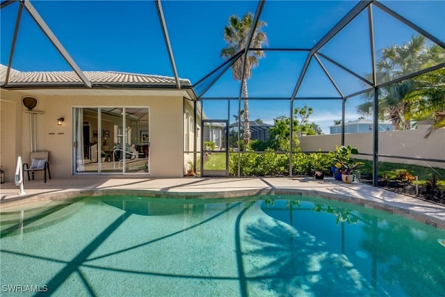 view of pool featuring a patio area, glass enclosure, and a fenced in pool