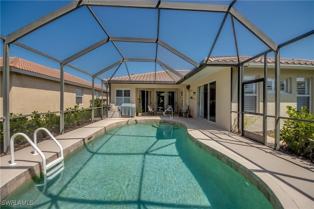 pool featuring glass enclosure, a patio, and a grill