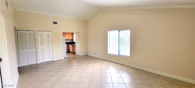 unfurnished bedroom featuring light tile patterned floors, two closets, high vaulted ceiling, and ornamental molding