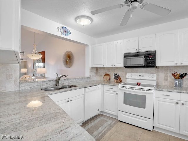 kitchen with white appliances, tasteful backsplash, white cabinetry, and light stone counters