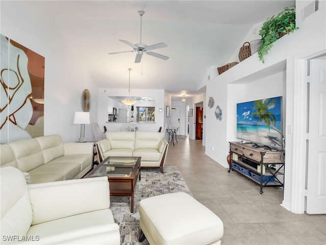 living room featuring light tile patterned floors, vaulted ceiling, and ceiling fan