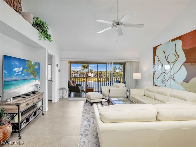 tiled living room featuring ceiling fan and vaulted ceiling