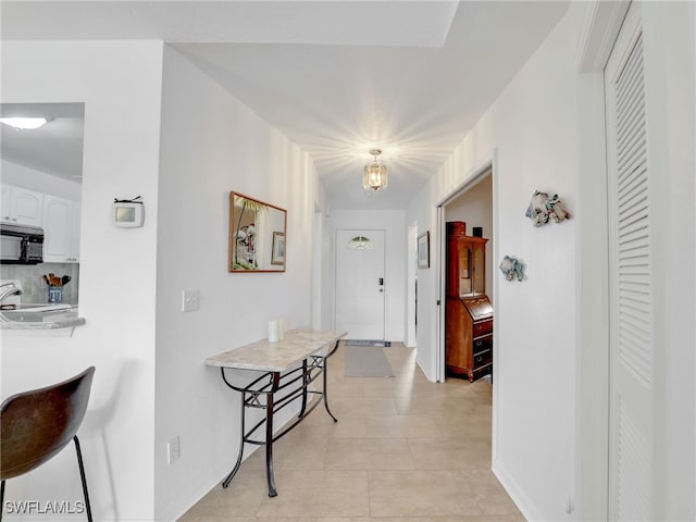 corridor featuring light tile patterned floors