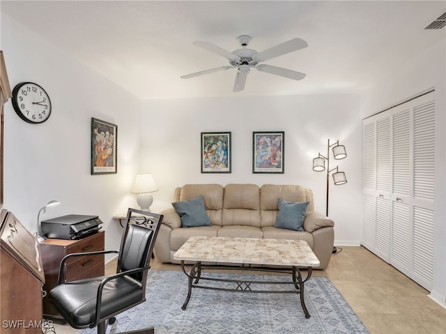 living room with light tile patterned floors and ceiling fan