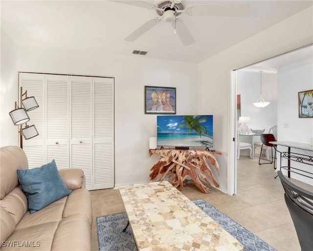 living room featuring ceiling fan and light tile patterned floors