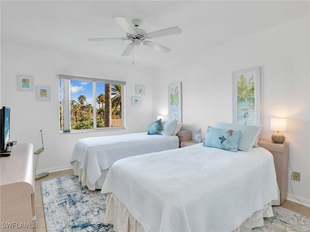 bedroom with ceiling fan and light hardwood / wood-style floors