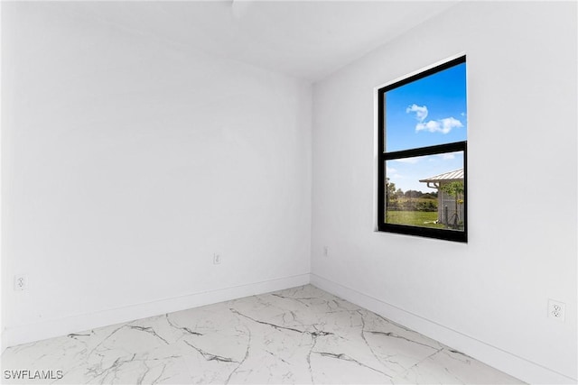 7029 Palpano Cir, Labelle, FL 33935 - spare room featuring marble finish flooring and baseboards