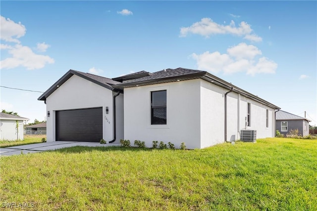 7029 Palpano Cir, Labelle, FL 33935 - view of property exterior with an attached garage, stucco siding, central air condition unit, and a lawn