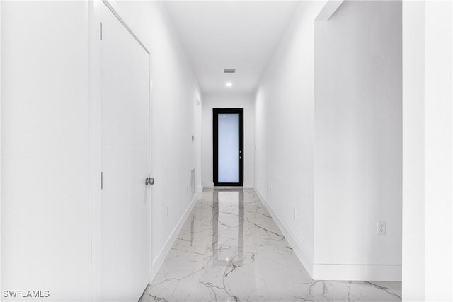 7029 Palpano Cir, Labelle, FL 33935 - corridor featuring light marble finish flooring, baseboards, and recessed lighting