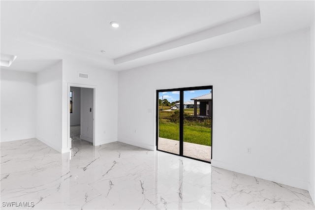 empty room featuring a tray ceiling