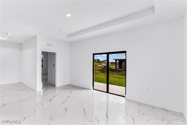 7029 Palpano Cir, Labelle, FL 33935 - spare room with a raised ceiling, marble tiled flooring, recessed lighting, and baseboards