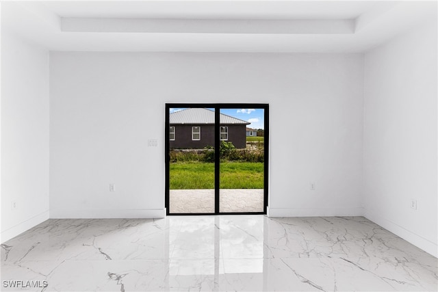 unfurnished room with a raised ceiling