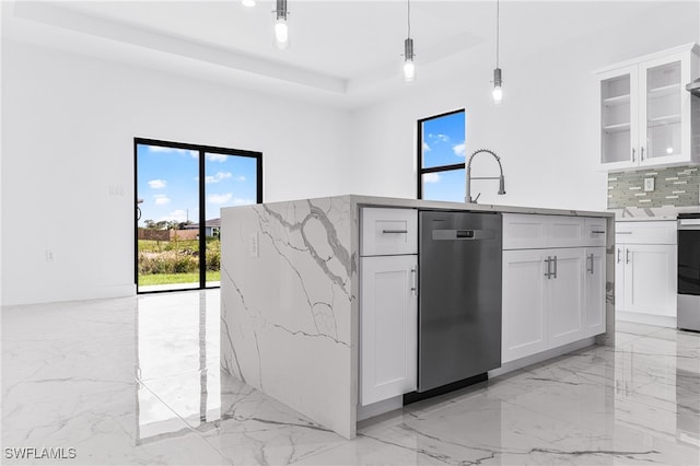 kitchen featuring pendant lighting, plenty of natural light, white cabinetry, and stainless steel appliances