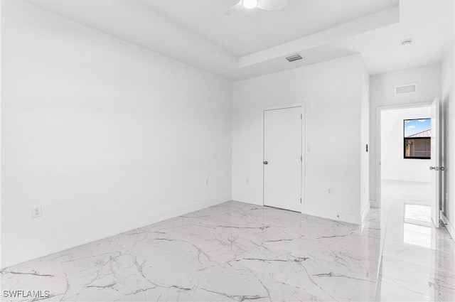7029 Palpano Cir, Labelle, FL 33935 - unfurnished bedroom with light marble finish flooring, ceiling fan, and baseboards