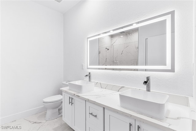 bathroom featuring vanity, toilet, and a shower