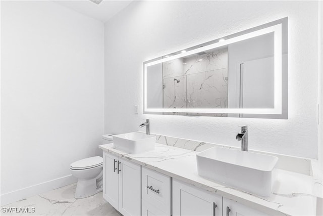7029 Palpano Cir, Labelle, FL 33935 - bathroom with marble finish flooring, toilet, double vanity, a marble finish shower, and baseboards