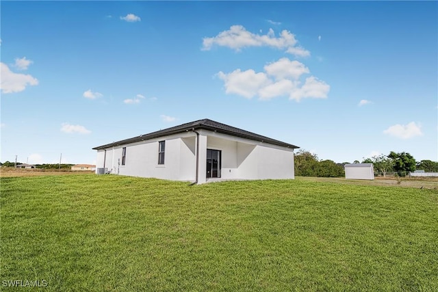 7029 Palpano Cir, Labelle, FL 33935 - back of property with a yard, stucco siding, and cooling unit