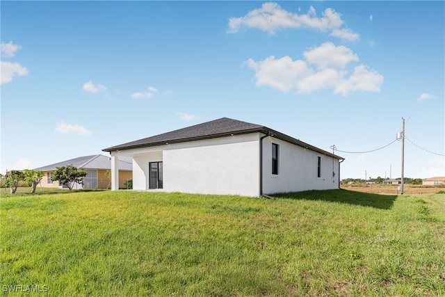 rear view of property with a lawn