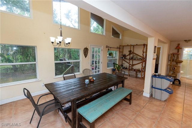 5051 Nature Way, Fort Myers, FL 33905 - dining area with a chandelier, light tile patterned floors, baseboards, and a towering ceiling