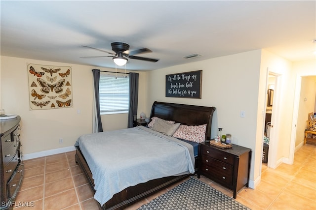 bedroom featuring visible vents, ceiling fan, baseboards, and light tile patterned flooring