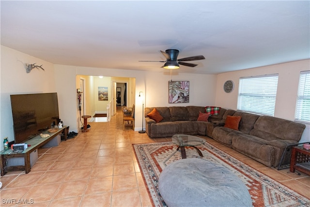 tiled living room with ceiling fan