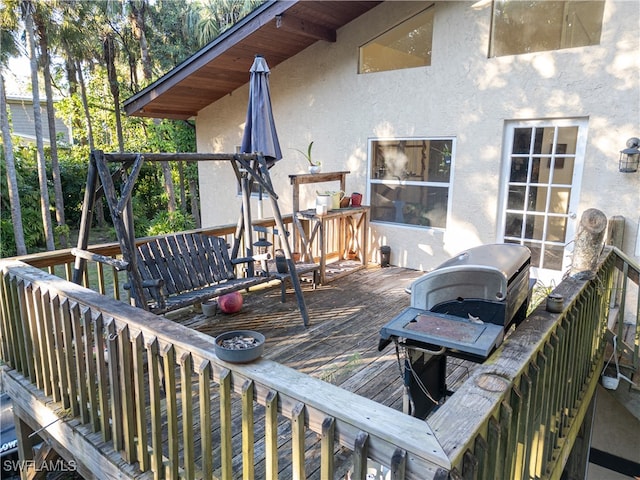 wooden terrace featuring area for grilling