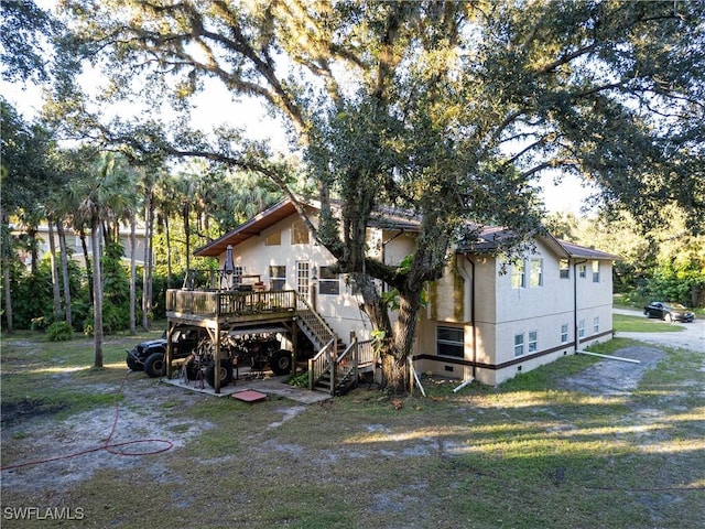 5051 Nature Way, Fort Myers, FL 33905 - rear view of house featuring stairway, a wooden deck, and stucco siding
