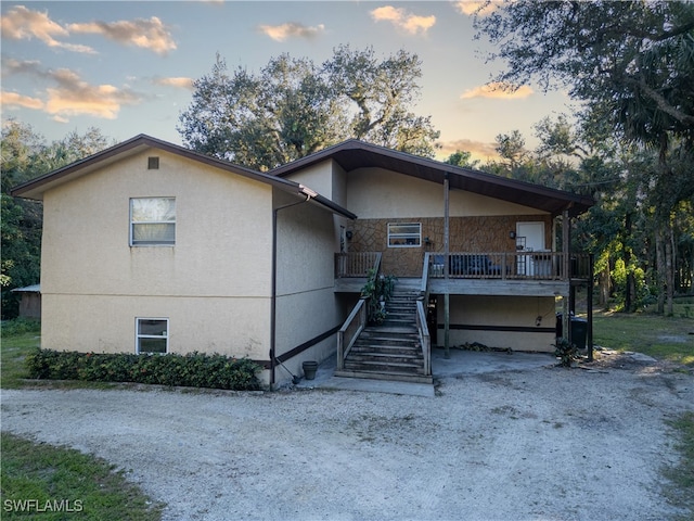 5051 Nature Way, Fort Myers, FL 33905 - view of front of house with stucco siding, stairs, and stone siding