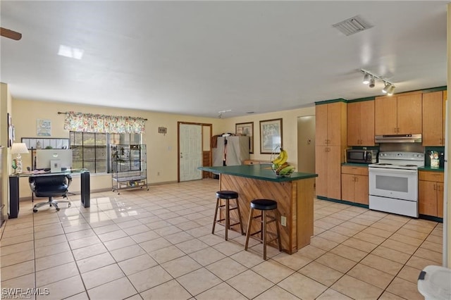 kitchen with white electric range oven, a kitchen breakfast bar, refrigerator, and light tile patterned flooring