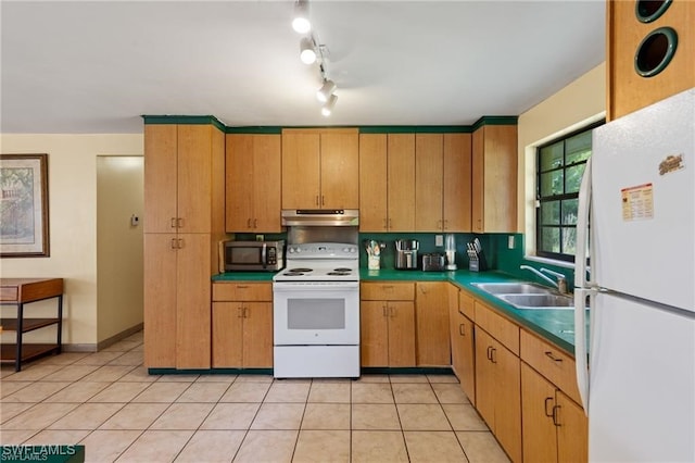 kitchen with sink, light tile patterned floors, and white appliances