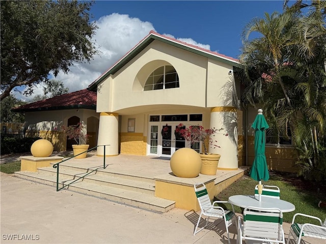 11510 Villa Grand Unit 407, Fort Myers, FL 33913 - rear view of house featuring a patio area, stucco siding, and outdoor dining space