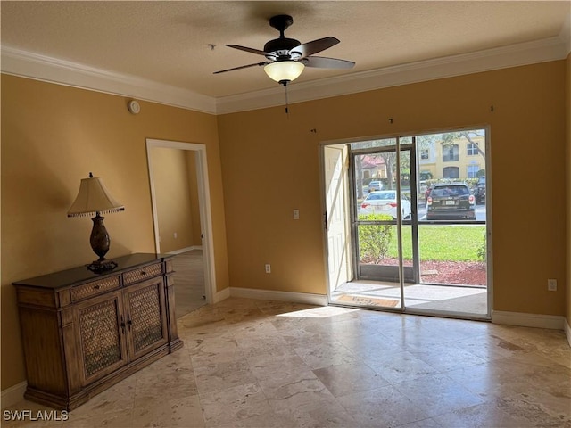 spare room featuring ceiling fan and crown molding