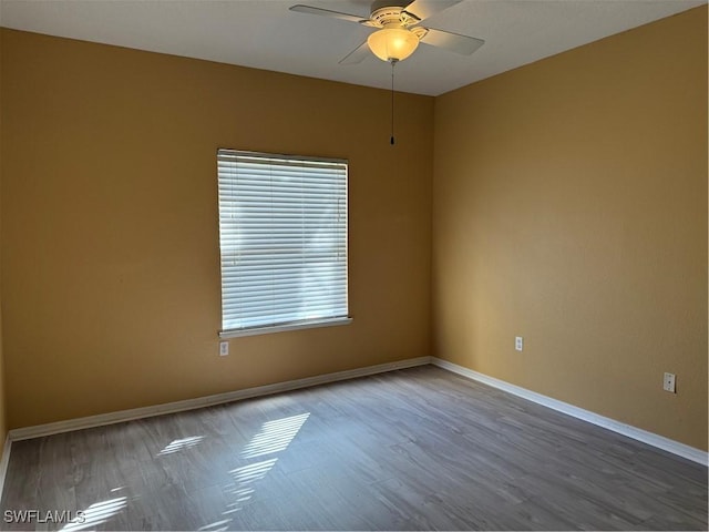 unfurnished room with hardwood / wood-style floors and ceiling fan